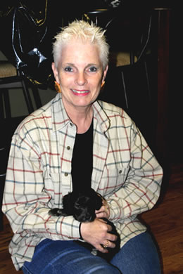Gail holding one of three puppies who could be Fleecy 10-25-2010